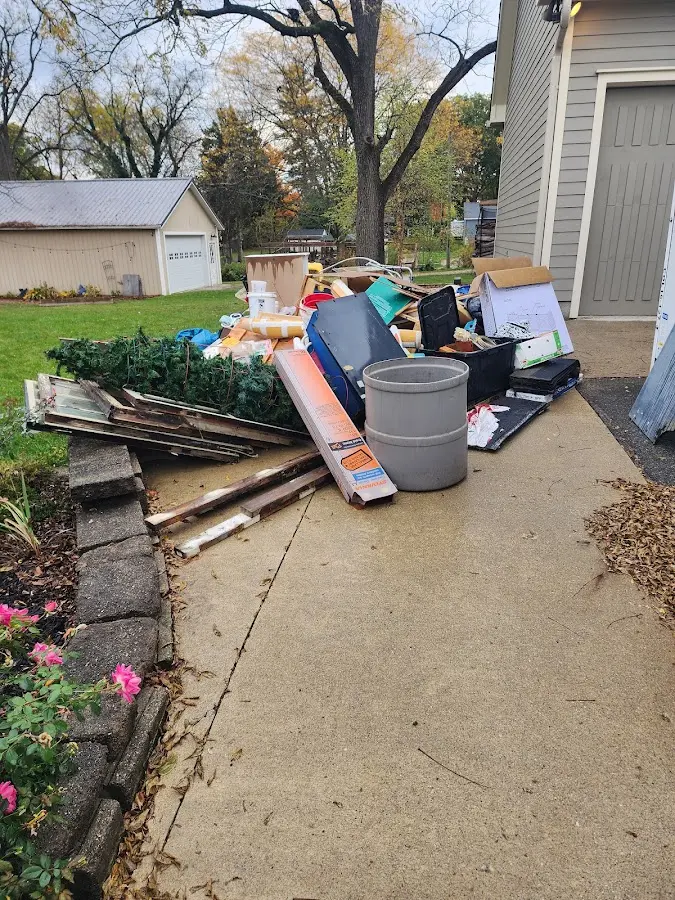 Dumpster being loaded with debris for Estate Cleanout Dumpster Rental in Port Clinton